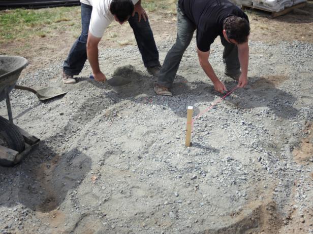 With the screwdriver or wooden stake still in the center, measure out a smaller radius from the center. Pull the string tight to this distance and create a small trench, which will outline the inner fire ring stone circle.