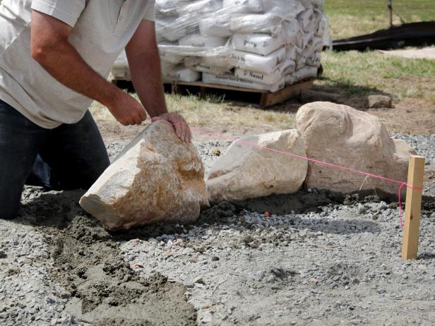 Continue to fill the trench with mortar and stones. Pull the 3' radius string to confirm distance from the center.