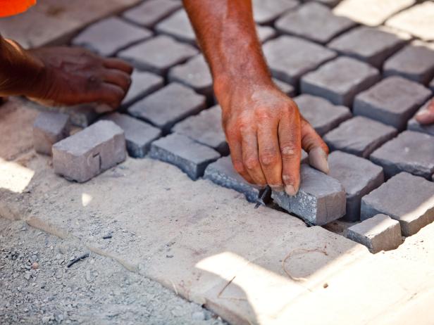 Continue laying sheets of stone until the walkway is filled. Add trimmed pieces to fill in the area.