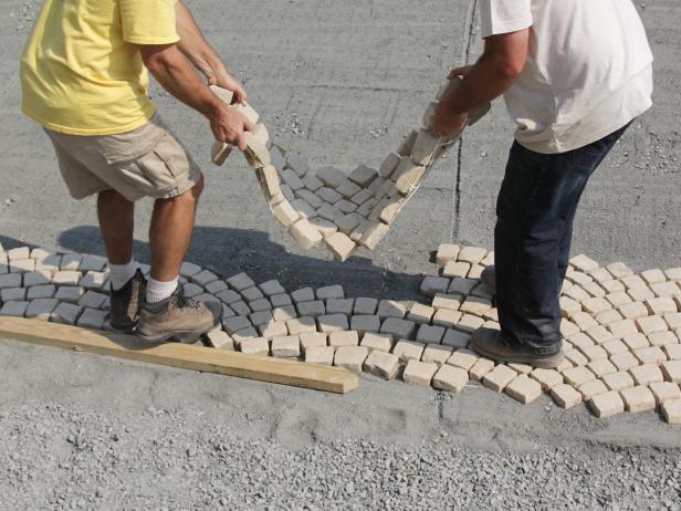 Lay your first sheet of stone on the prepared base. Then, continue laying your sheets so that they connect and cover the entire area.