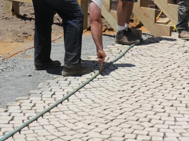 If a fan design is laid, trim the sharp edge, but first, draw the cut line on the stone using a marking pencil.