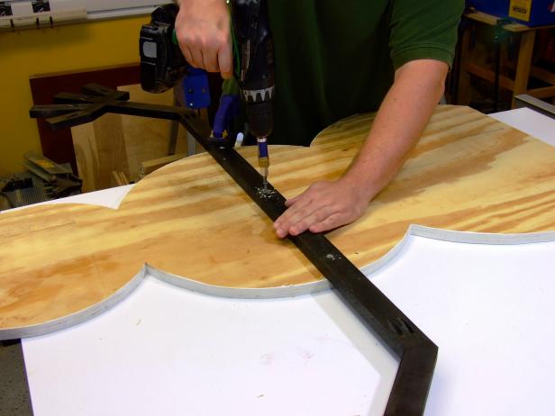 Lay the body facedown. Position the arm/hand assembly roughly centered on the middle circle of the body. Attach the arm assembly to the body using three 1-1/4-inch deck screws and no glue