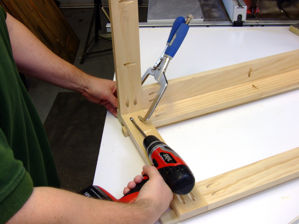 Position the end of the end rail assemblies with the vertical pocket holes flush against the end of one of the side rail/leg assemblies, and attach using glue and 1-1/4-inch pocket-hole screws. Drive the screws through the end rails and stiles and into the legs.