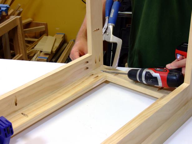 Position the other side rail/leg assembly.