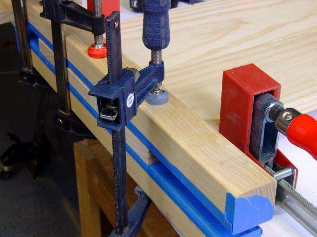 Position clamping cauls against the headboard panels and butted against the bar clamps, and clamp lightly in place.