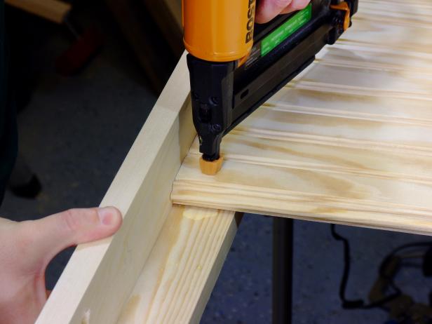 Attach the slats to the front rails using glue and 1-1/4-inch wire brads.