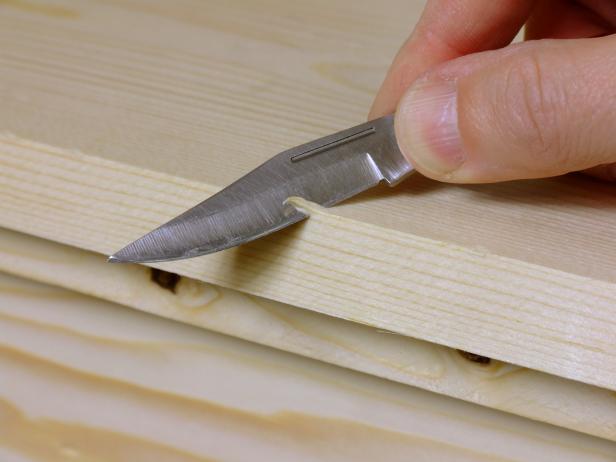 Create worn or chipped edges by cutting notches using a pocket knife or utility knife.