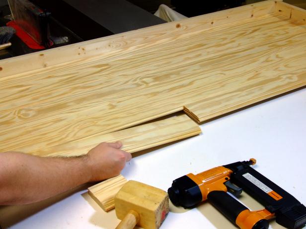 Starting at the footer assembly end, begin alternating placing the long slats and short slats. Cut from tongue-and-groove pine.