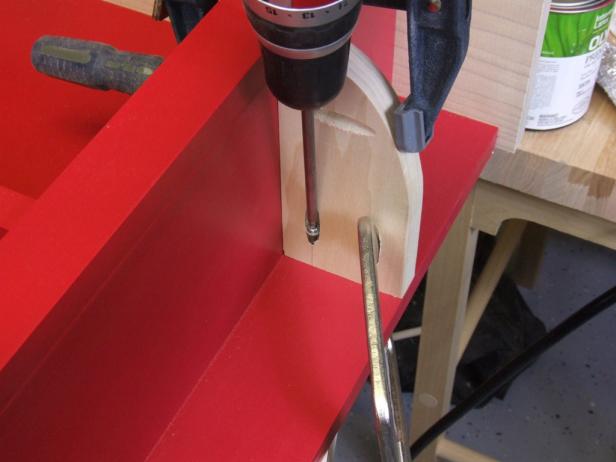 Position one side shelf 5-9/16 inches from the top and attach to the back and sides using glue and 1-1/4-inch pocket-hole screws.