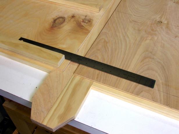 Position the side panel assemblies flush with the back panel assembly and scribe the position of the shelf supports onto the side panel assemblies.