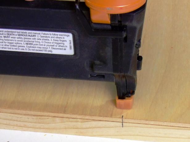 Position the back panel centered and flush with the top of one of the assemblies (be sure to place the panel on the pocket-hole side) and attach using glue and #18 x 5/8-inch wire brads. Label this the back assembly.