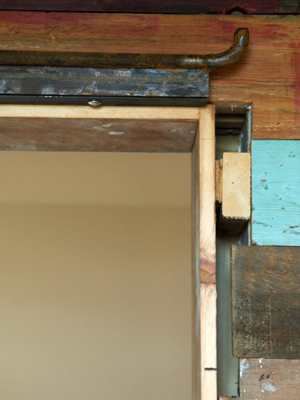 With a helper, level and mark the wall-mounting track at the correct height.