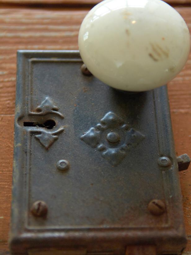 Remove hardware, like this doorknob, from door and keep them for later projects.