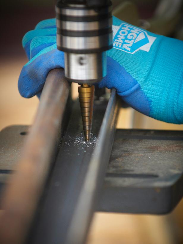 Place three equally spaced bolts in the door header. Place one bolt into each stud. Drill the marked holes in the angle iron to 1/2".