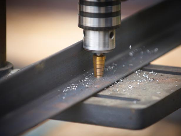 Drill the marked holes in the angle iron to 1/2". Do not drill holes into the wall at this time.