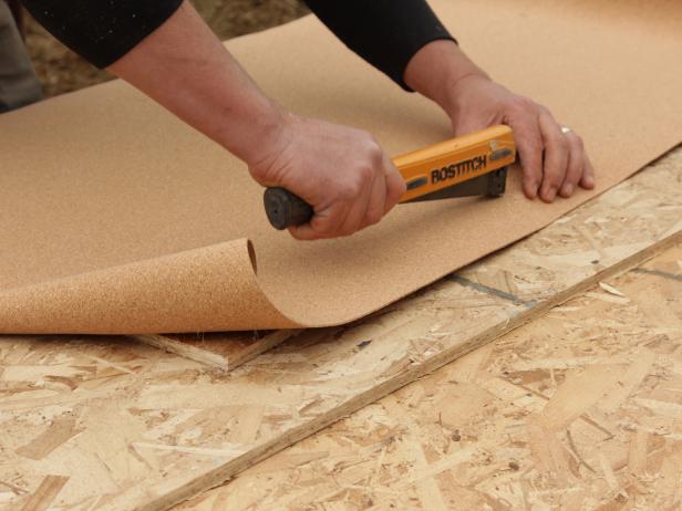Use a hammer-tacker to staple the cork around the edges of the board.
