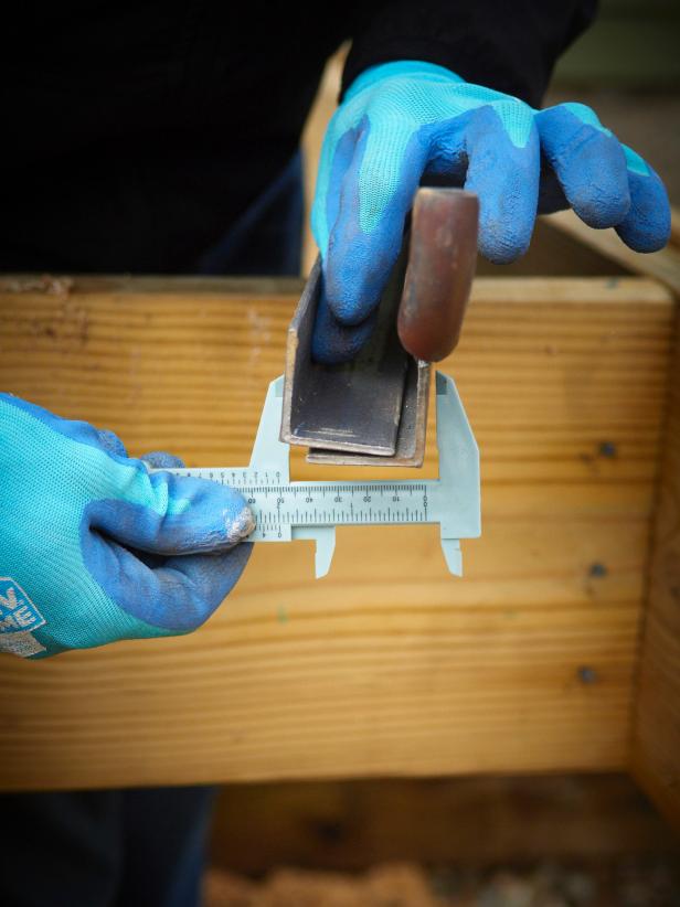 The two pieces of angle iron will be oriented so they form a "U" channel. Total track depth will be less than 2" so the door fits tight against the wall. To create channel, offset the two pieces of track for the correct depth and clamp each end with vice grips.