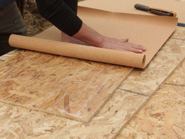 Start at one end and evenly roll cork across the sheathing.