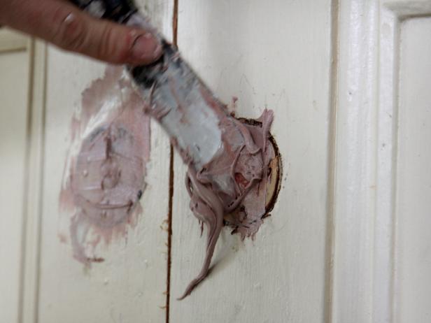 Next, mix up a can of automotive body filler and fill any large holes from removed door hardware.