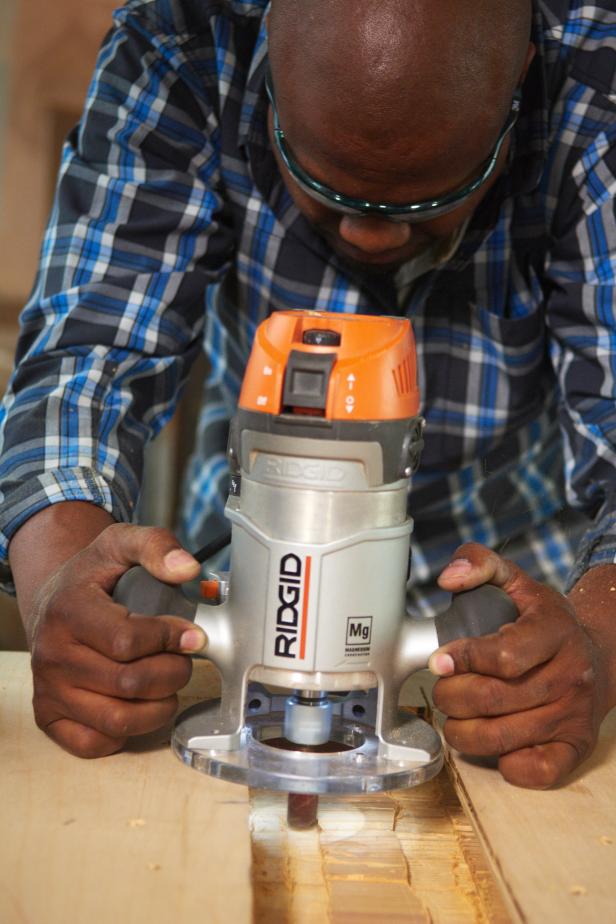 Chris Grundy uses a tool to cut wood for office desk.