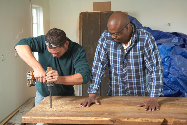 Using a long pilot bit, drill perpendicular to the board and through the top.