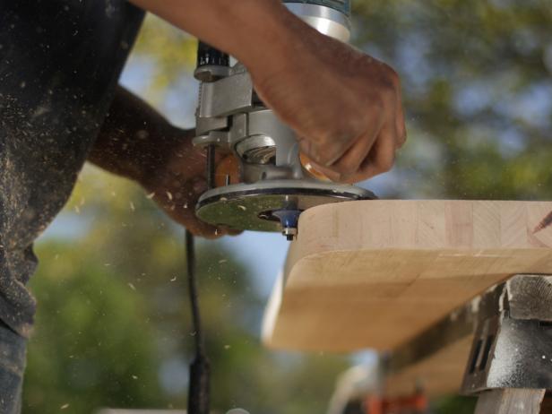 Secure the butcher block to a work surface with padded clamps. Using a 3/8” roundover bit and working slowly, run the bit along the perimeter of the butcher block on both the top and bottom edges.