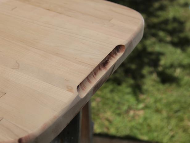 Using the 1/2" cove bit and starting in the center of each mark, work out to remove the length of material to create finger-holds. Using a piece of sandpaper, remove any burned or burnished spots.