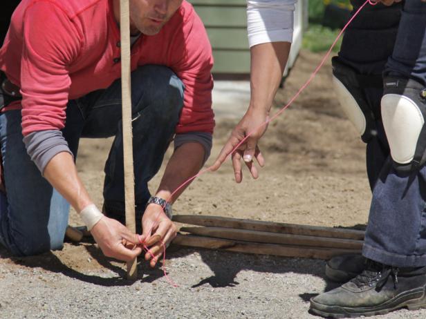 Establish the points along the 'compass' by tying mason's string around the stakes.