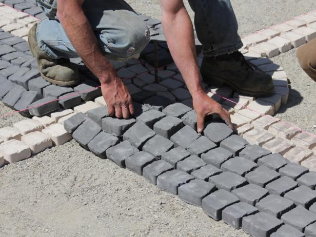 Adjust the cobblestone mats and place stones individually as needed.