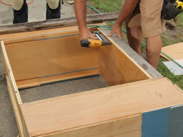 Align cabinets at the top by infilling the bottoms of any short cabinets with toe kicks made from reclaimed wood.