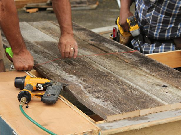 Using a framing square, ensure board is perpendicular to the cabinet before driving a second screw in board at the bottom.