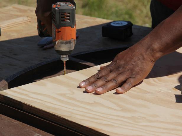 Attach plywood with 1-1/2" wood screws at least 12" on center. Drill the base plywood into the table top.