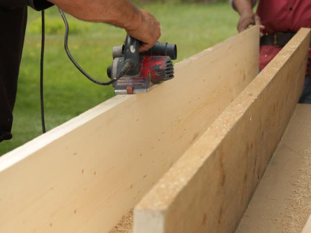 Sand the tabletop with a wide-belt hand-held sander. Keep belt perpendicular to plank joints and move back and forth in a direction parallel to joints.