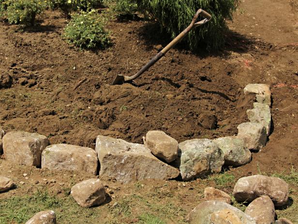 Once the soil is mixed and clumps removed, dump it directly into the raised bed and fill until even with the top of the wall.