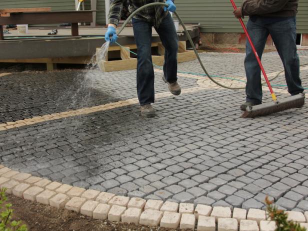 Wetting the cobblestone before applying the sand/epoxy mix helps keep the mix from sticking to the stone.
