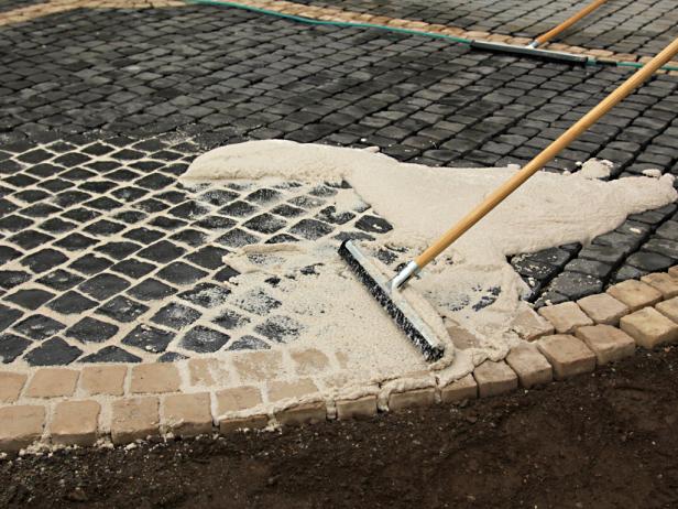 After laying the stones in place, use a neoprene squigee to work the sand/epoxy mix into the cobblestone grooves.