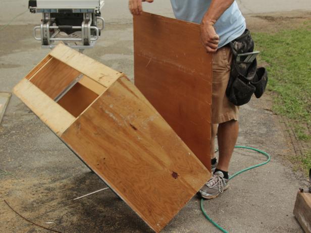 Fence boards will serve as a vertical wall treatment for this piece of furniture. To achieve this custom look, first carefully remove the cabinet back panels.