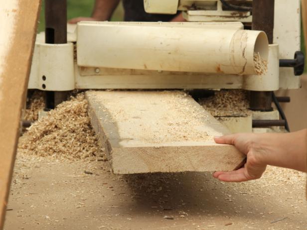 Run planks though the planer, stripping a small amount of wood from each side as you plane. While the board is going through the planer, manually adjust the depth of the cut to compensate for irregular thickness (or twist) over the board’s length.