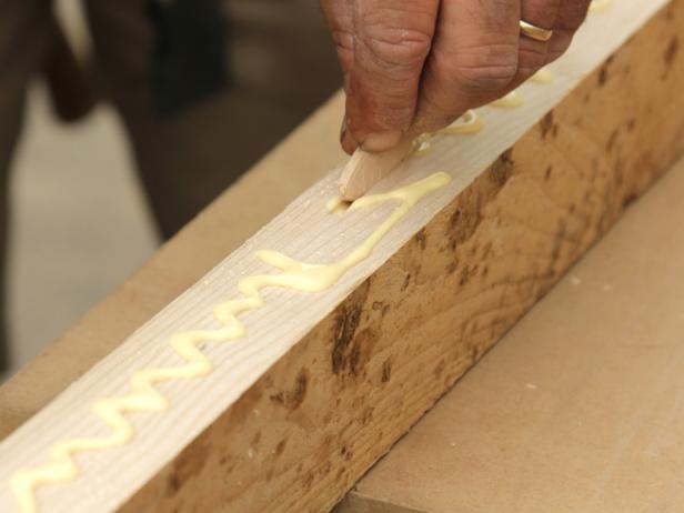After all slots are cut, stand each board on end and coat the edge of jointed side with wood glue. Next coat the biscuits with glue. Insert biscuits in one side only of each board, then insert glued biscuits in the empty joint of the next board.