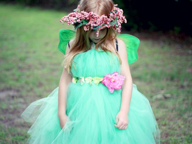 Make a standard tutu skirt (very easy) long enough to serve as a dress. Add a halter ribbon, a set of wings, adorn it with a floral belt and a pretty halo. Design by Jess Abbott.