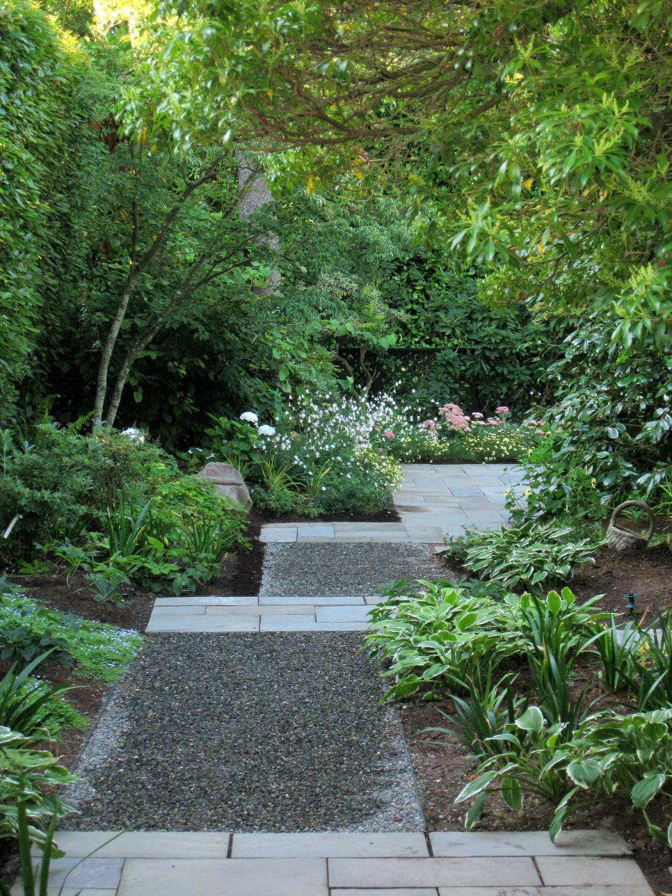 Backyard Walkway Ideas this sparse spaced out flagstone walkway splits around a triangular garden Pictures Of Garden Pathways And Walkways Diy Backyard Walkway Ideas 38 gorgeous garden paths backyard walkwaywalkway ideasstone Pictures Of Garden Pathways And Walkways Diy