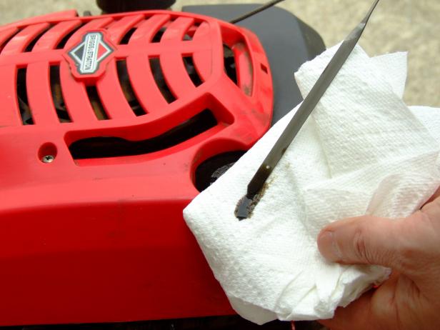CI-Chris-Hill_-lawnmower-checking-the-oil_h CI-Chris-Hill_-lawnmower-checking-the-oil_h