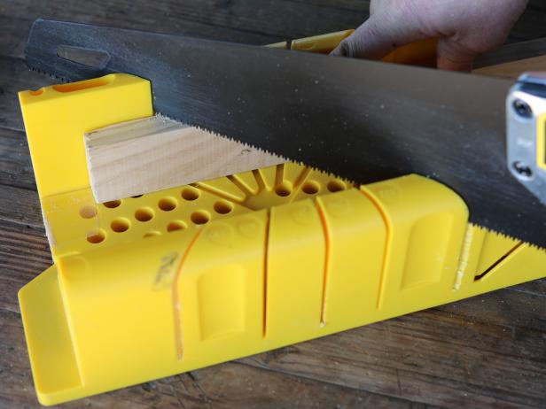 Cut 1x2â pine or birch trim to size, then miter the edges using miter saw.