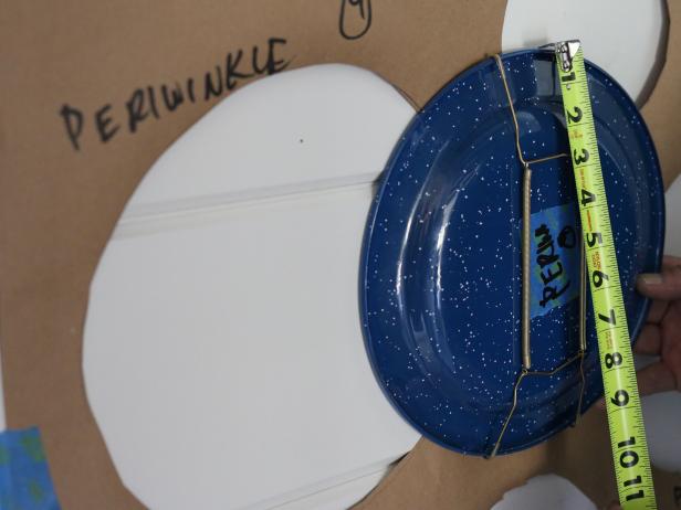 Hold plate in its proper position, then use measuring tape to determine the distance from the top of the plate to the plate hanger nail. Mark this placement with the pencil.