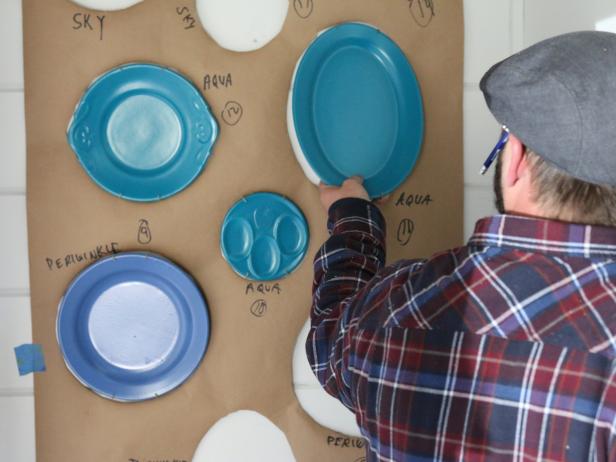 Once all plate hanger nails are attached, add plate hangers to all plates, then position them in place.