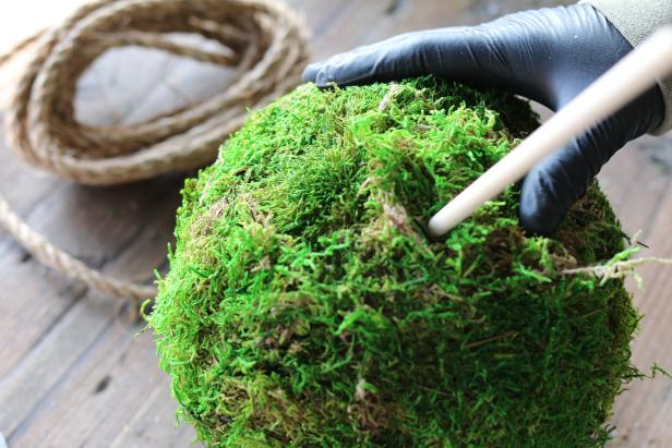 In order for the moss spheres to hang properly, youâll need to create a hollow channel down the center of the foam through which to thread sisal rope. To do this, add pressure to the dowel until it goes all the way through to the bottom.