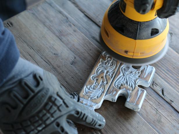 Once carved wooden objects have been coated with flat white spray paint, youâll simply need to use an orbital sander with fine grit sanding pads to create a whitewashed look. Randomly move the sander back and forth along the surface until enough spray paint is removed, resulting in a weathered, peeled back look