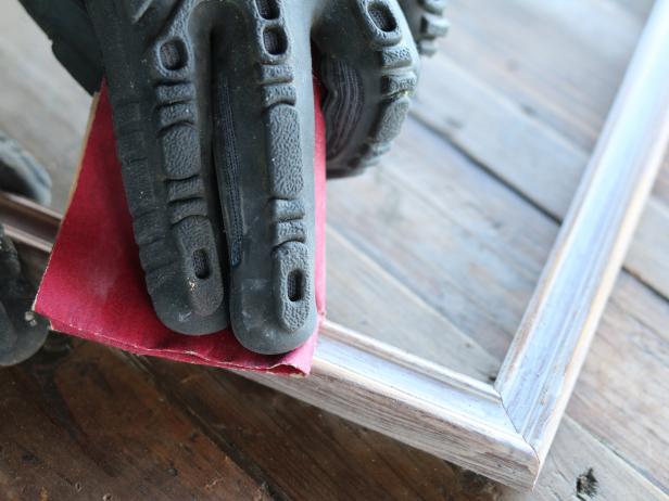 After the brushed paint has 12dried on the frames, use fine grit sandpaper along the edges of the frame to lightly knock the paint down. This will result in a worn, aged look.