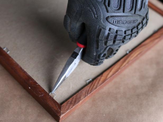 If youâre updating a wooden picture frame, itâs much more efficient to remove the back panel, art and glass from the frame rather than masking it with painterâs tape and paper. Use needle nose pliers or drill to remove the back panel from the frame, then set the frame aside on craft paper.