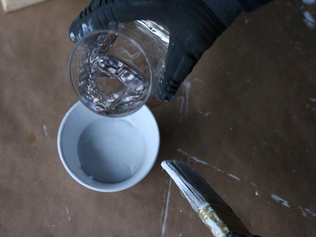 To create the whitewash, mix 2 parts flat white latex paint with 1 part water. Then dip paint brush into the mix and stir it around until an even consistency forms.